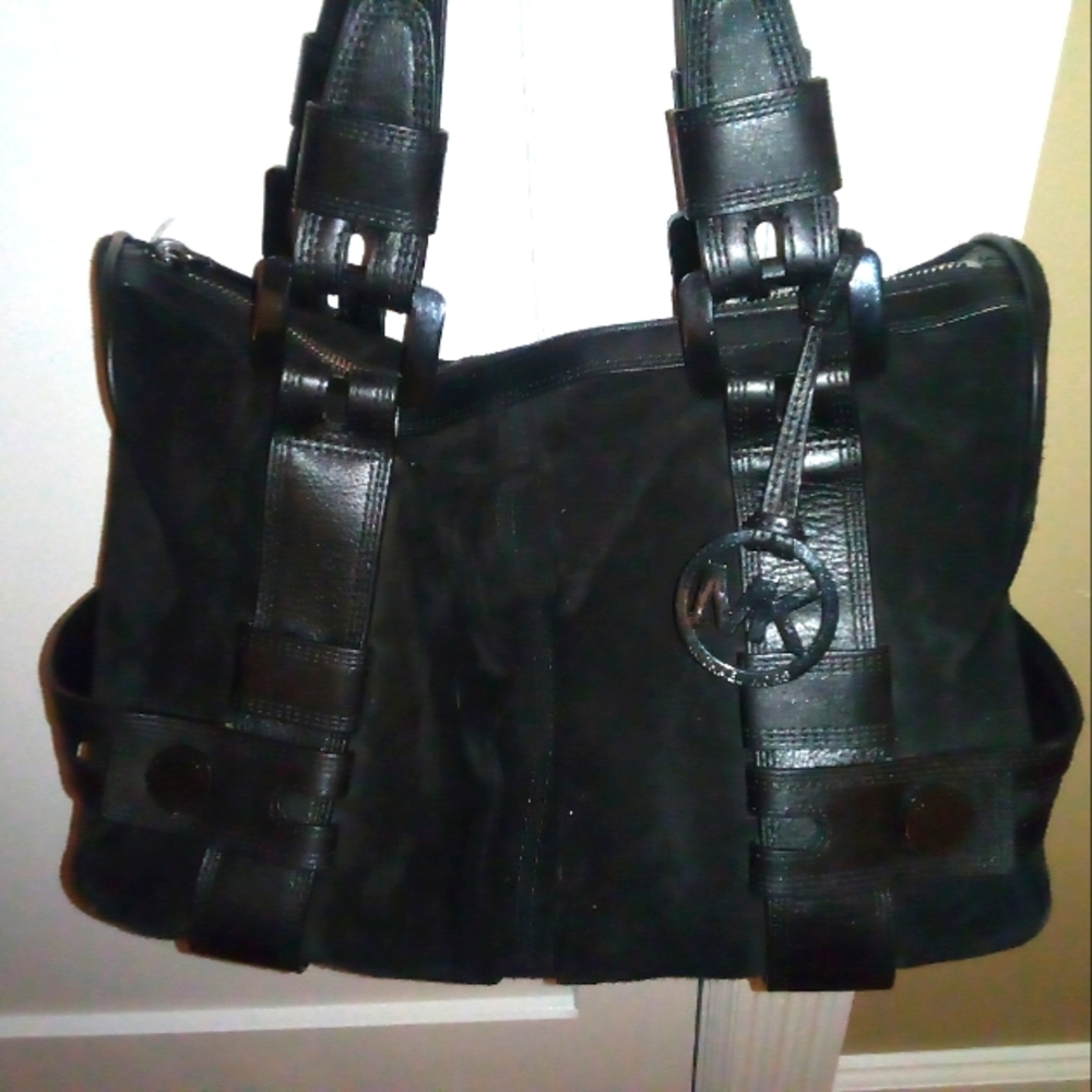 Michael Kors. It's black suede leather very roomy. I might trade also